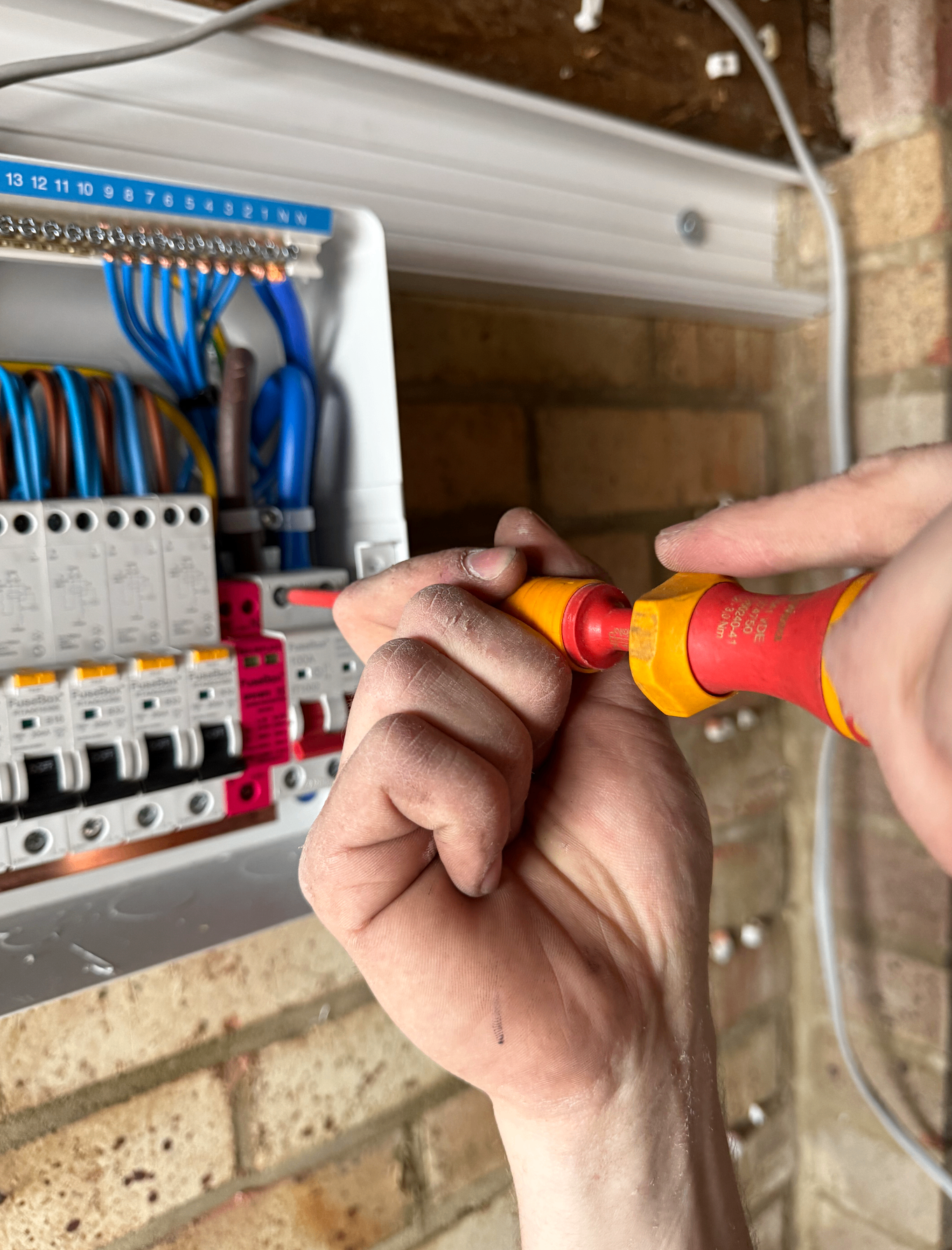 Electrician wiring a FuseBox consumer unit